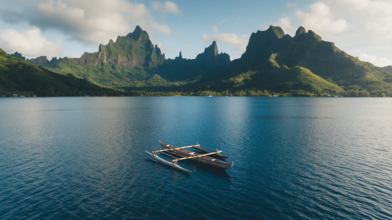 Outrigger canoe on Cook's Bay with the jagged mountains of Moorea behind